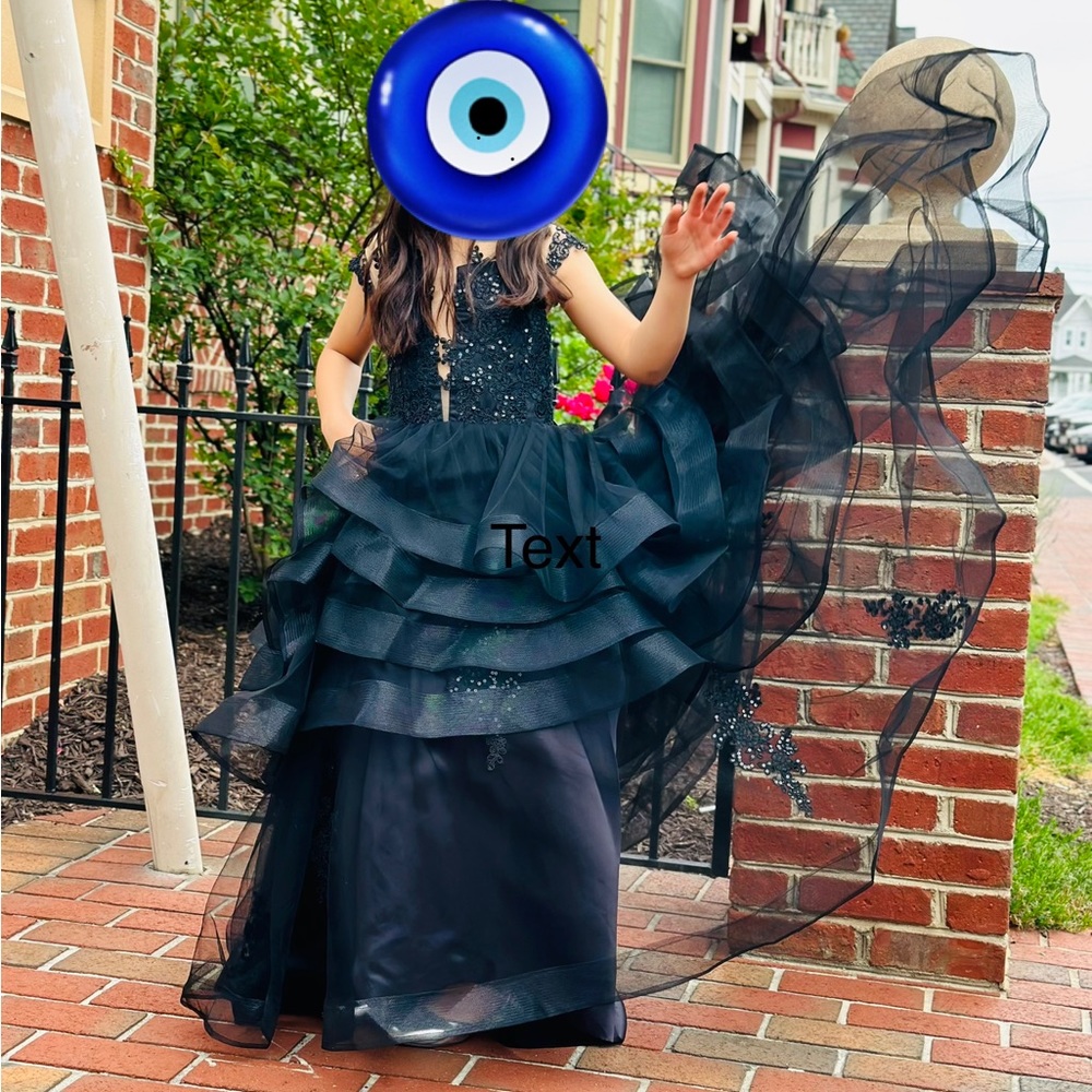 An elegant black dress for girls in 6-7sizes with a tail
